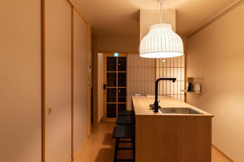 a kitchen with a sink and a pendant light at Kiraku Wheat Kiyomizu Temple Absolute Garden and Terrace Designer Studio in Kyoto