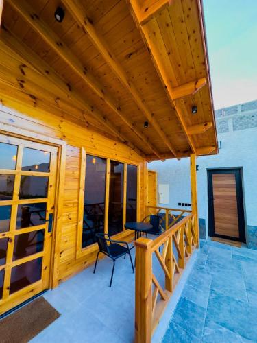 a wooden deck with chairs and a table on it at أكواخ البرنسيسة in Jeddah