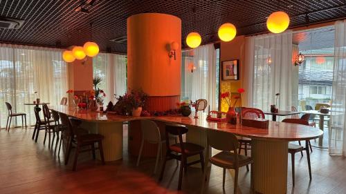 a dining room with a large table and chairs at Gardina Asoke Hotel & Residence in Bangkok