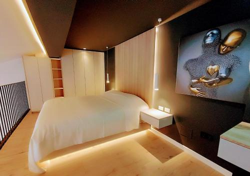 a bedroom with a large bed and a tv on the wall at Tirana Sunset Retreat Stylish Loft by the Lake Park in Sauk