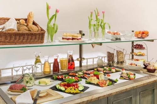 a buffet with many plates of food on a table at Der Kronprinz in Fuhrbach