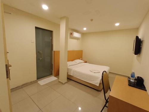 a small room with a bed and a shower at South of The Clouds HOTEL KL Sentral 吉隆坡彩云之南酒店-中央车站店 in Kuala Lumpur