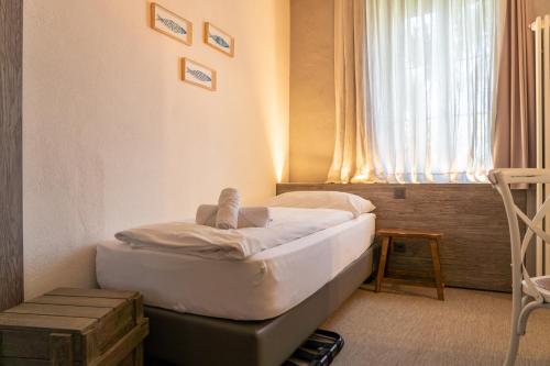a small bed in a room with a window at Seven Boutique Hotel in Ascona