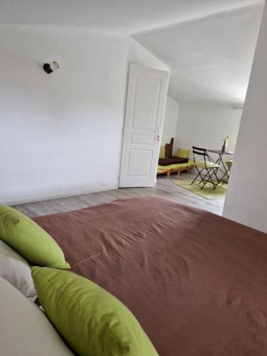 a living room with a couch and a room with a table at Chambres d'hôtes La Frise in Corpe