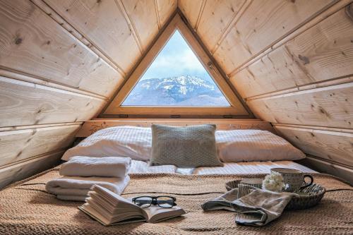 a bed in a small room with a window at Odkryj-Zakopane Tatra View Houses & SPA in Kościelisko