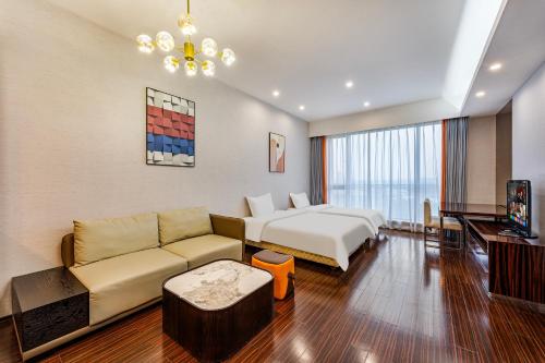a hotel room with a couch and a bed at eStay Residence·Poly World Trade Center Guangzhou in Guangzhou