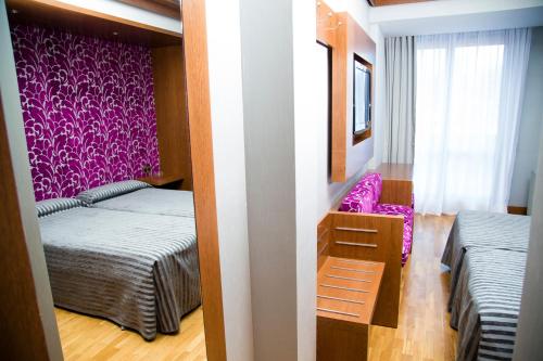 Ένα ή περισσότερα κρεβάτια σε δωμάτιο στο Hotel Los Braseros