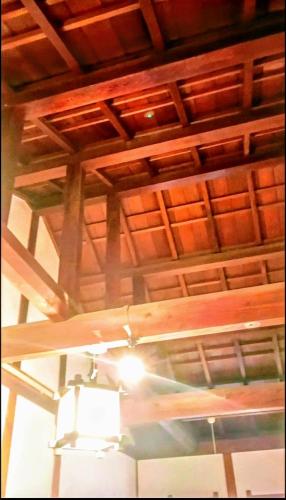 a ceiling of a room with a light on it at Ryokan Gallery Tokyo in Kamagaya