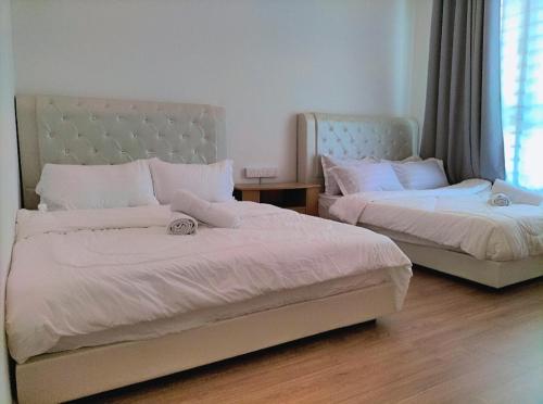 a bedroom with two beds and a window at New Akina Kajang2 Homestay 12pax in Semenyih