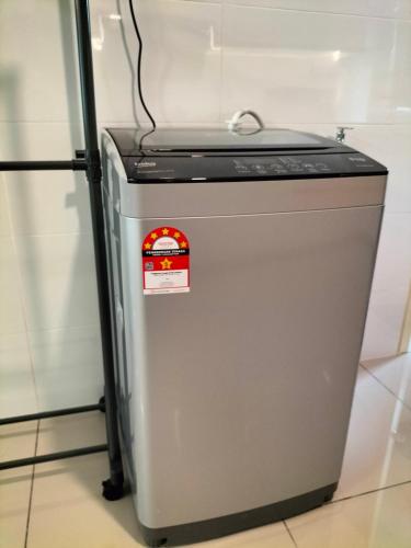 a small refrigerator with a red sticker on it at New Akina Kajang2 Homestay 12pax in Semenyih