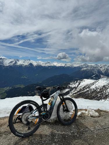 a bike parked on top of a snow covered mountain at Martinshof Ladis in Ladis