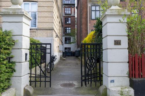 an entrance to a building with a iron gate at Unique 3 Bedroom Apartment in Vibrant Frederiksberg in Copenhagen