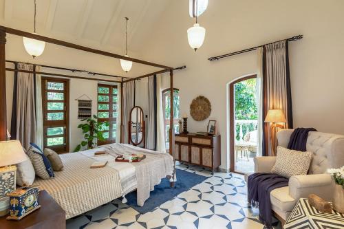 a living room with a bed and a couch at LohonoStays Villa Brisa in Anjuna