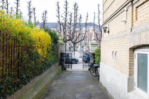 an alley with a bike parked next to a building at Unique 3 Bedroom Apartment in Vibrant Frederiksberg in Copenhagen