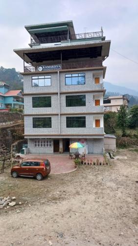 a building with a car parked in front of it at Twin Garden in Gangtok
