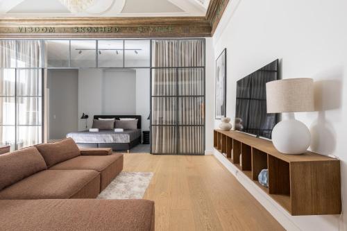a living room with a couch and a tv at Unique 3 Bedroom Apartment in Vibrant Frederiksberg in Copenhagen