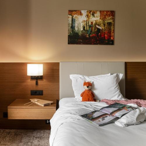 a teddy bear sitting on top of a bed at Hyatt Regency Thessaloniki in Thessaloniki