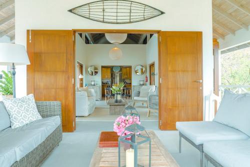 a living room with a couch and a table at Stunning 4 bed Villa in Bequia St Vincent in Bequia