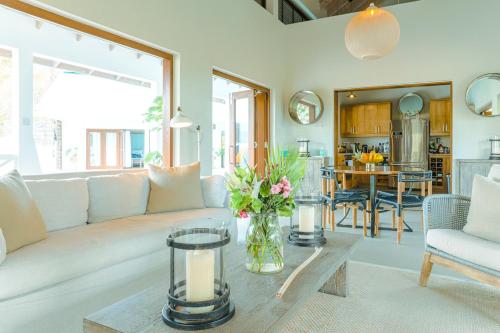 a living room with a white couch and a table at Stunning 4 bed Villa in Bequia St Vincent in Bequia