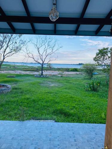 a porch with a view of a field of grass at Lago Inn in Tissamaharama