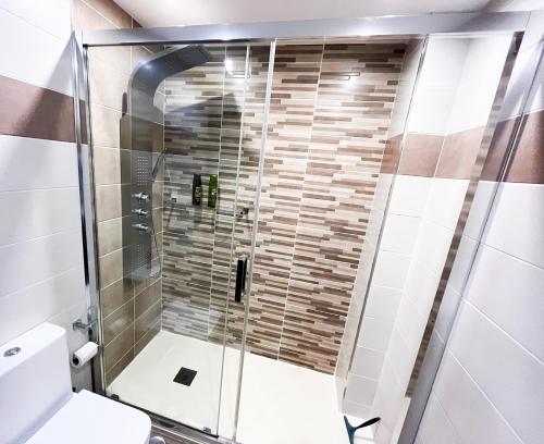 a shower with a glass door in a bathroom at Europa II in Calpe