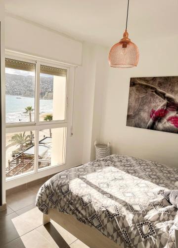 a bedroom with a bed with a view of the ocean at Europa II in Calpe