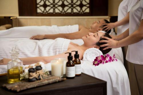 a woman laying in a bed getting a massage at Londoner Grand, a Luxury Collection Hotel, Macau in Macau