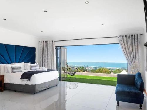 a bedroom with a king sized bed and a large window at At 40 Oceanview in Durban