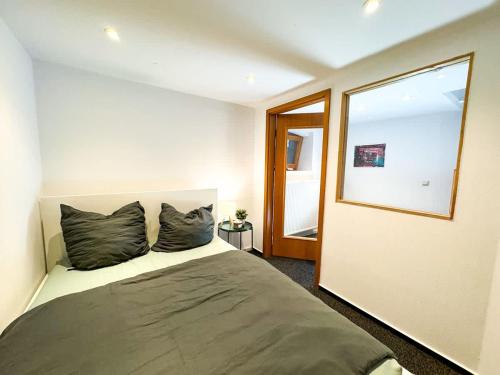 a bedroom with a bed with two pillows on it at Apartment for large groups south of Berlin in Großbeeren