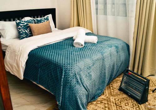 Postel nebo postele na pokoji v ubytování Elegant 2BR Apartment in Nanyuki