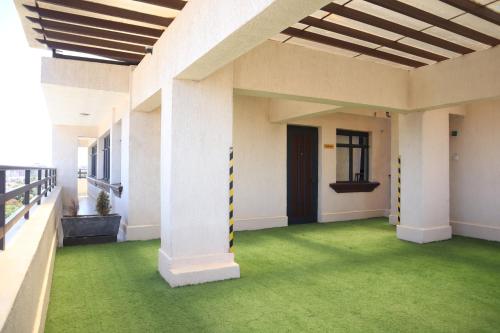 an empty room with green flooring in a building at Homey Haven in Juja
