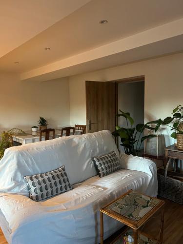 un canapé blanc dans un salon avec une table dans l'établissement Maison à 20 min des plages de Sainte Maxime, au Muy