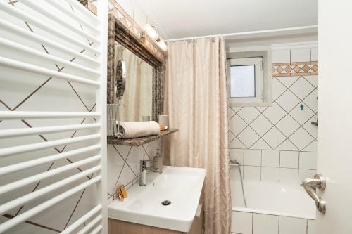 a bathroom with a tub and a sink and a shower at Niki Apartment in Athens