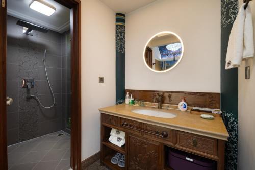 a bathroom with a sink and a shower at Datong Yunzhong Traditional Courtyard in Datong