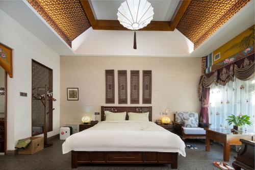 a bedroom with a large bed and a living room at Datong Yunzhong Traditional Courtyard in Datong