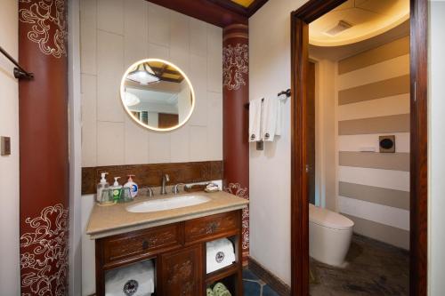 a bathroom with a sink and a mirror at Datong Yunzhong Traditional Courtyard in Datong