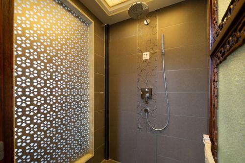 a bathroom with a shower with a glass door at Datong Yunzhong Traditional Courtyard in Datong