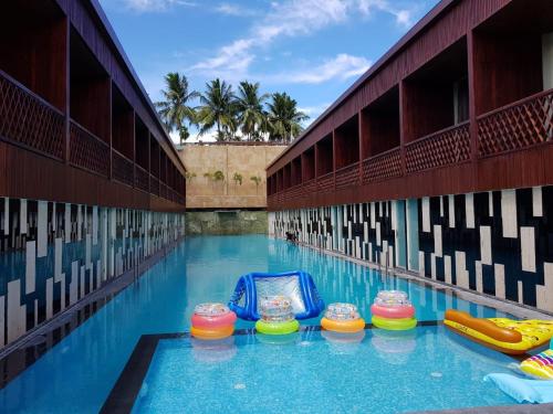 a pool at a resort with a pool slide at Haywizz Havelock Island Resort in Havelock Island