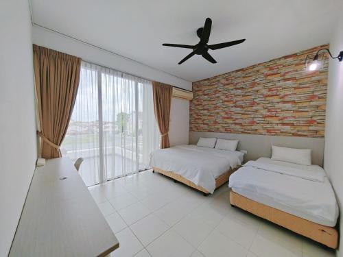 a bedroom with two beds and a brick wall at 2 Spacious Lupsxury conor villa garden Parking group family gathering wedding in Gelugor