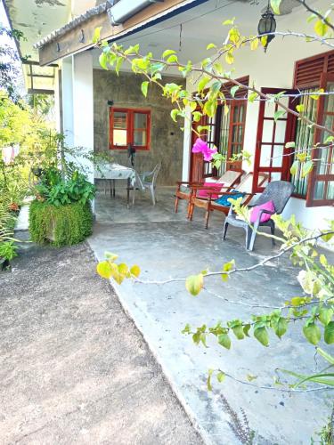a patio of a house with chairs and a table at new blue lotus in Mirissa