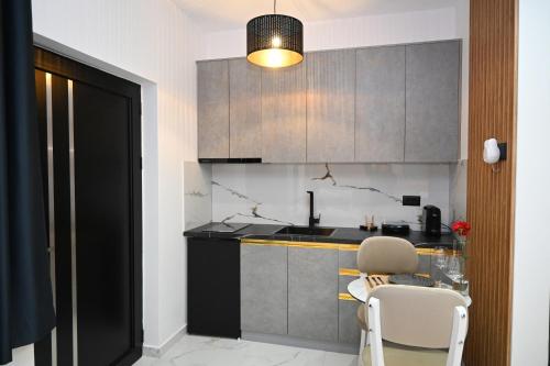 a kitchen with a sink and a table and chairs at Vila La Familia in Ksamil