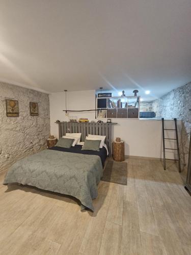 a bedroom with a bed and a stone wall at Quinta da Quinta in Vieira do Minho