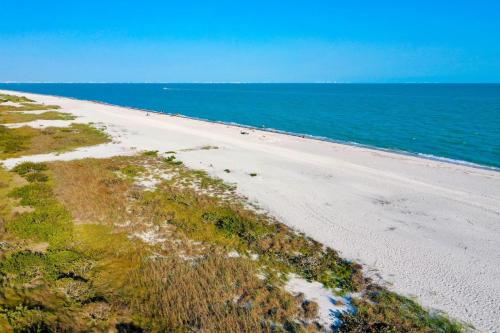 an aerial view of a sandy beach next to the ocean at Sandpiper Beach #405 in Sanibel