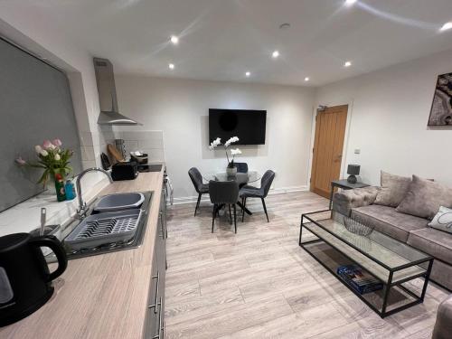 a living room with a couch and a table at Apartment 1 The Baileys Cwm 2 Bedroom Sleeps 4 in Cwm