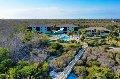 an aerial view of a resort with a pool and a house at Sandpiper Beach #405 in Sanibel