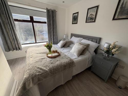 a bedroom with a bed and a window at Apartment 1 The Baileys Cwm 2 Bedroom Sleeps 4 in Cwm