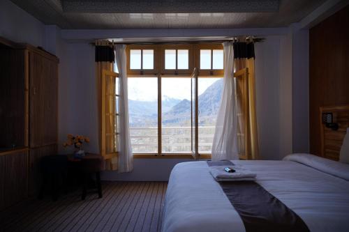 Ένα ή περισσότερα κρεβάτια σε δωμάτιο στο Hunza Elites hotel