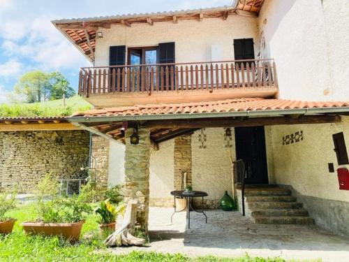 a house with a balcony on the side of it at LUNA dei CARLINI in Mombarcaro
