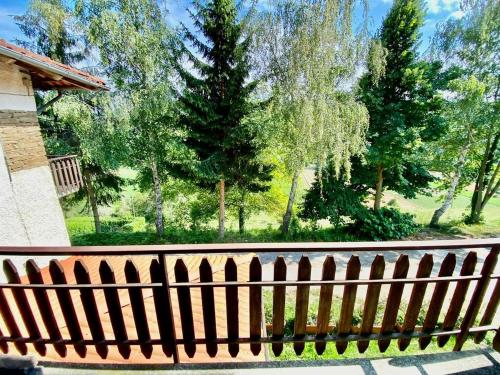 a wooden fence with trees in the background at LUNA dei CARLINI in Mombarcaro