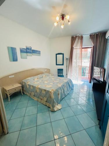a bedroom with a bed sitting on a tiled floor at casa la perla in Minori